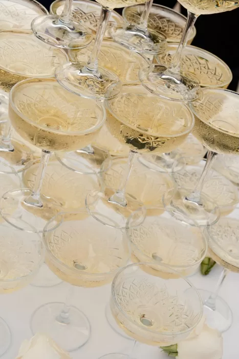 Close-up of sparkling champagne coupes stacked for a toast at Hospes Maricel & Spa wedding.