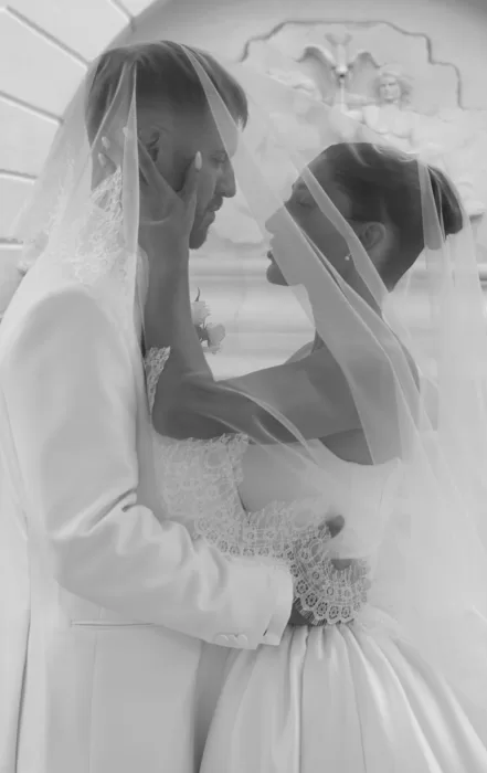 Romantic black and white moment of the bride and groom embracing under her lace veil at Hospes Maricel & Spa.