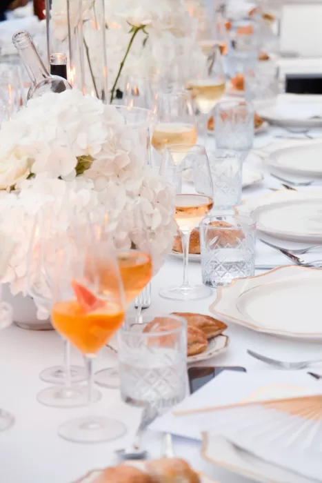 Sophisticated wedding reception table with white florals and crystal glassware at Hospes Maricel & Spa.