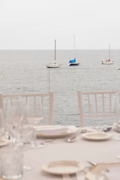 Serene sea view from the wedding dining area at Hospes Maricel & Spa with sailboats in the distance.
