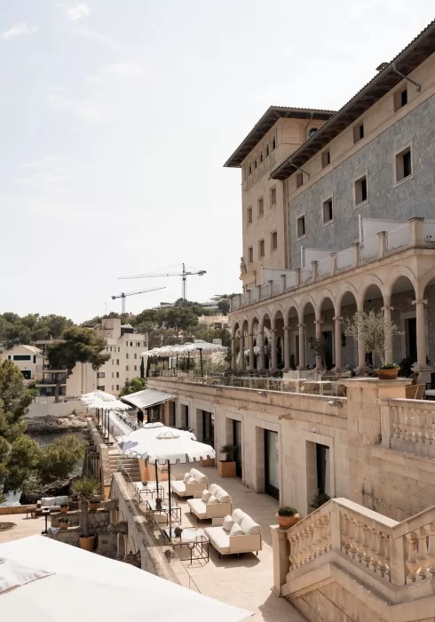 Elegant stone arches and terraces of Hospes Maricel & Spa overlooking the sea.