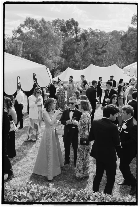Guests mingling outdoors under white tents at Le Mas Barossa vineyard wedding.