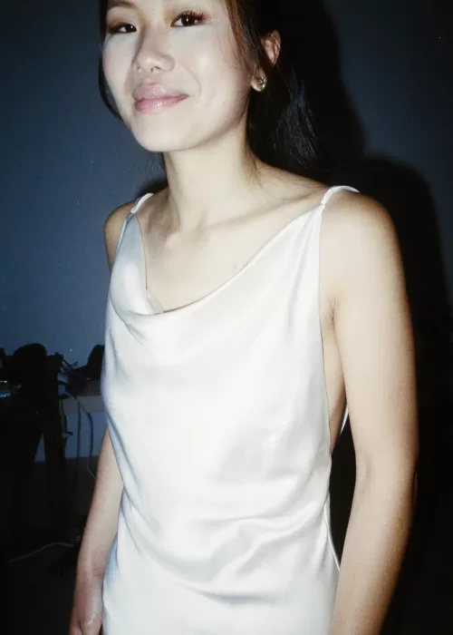 Bride smiling softly in a silk gown captured in intimate detail at Neuendorf House.