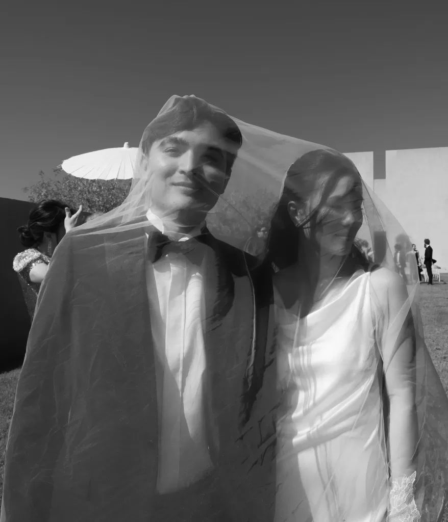 Bride and groom smiling under the bride’s veil during their modern Neuendorf House wedding.