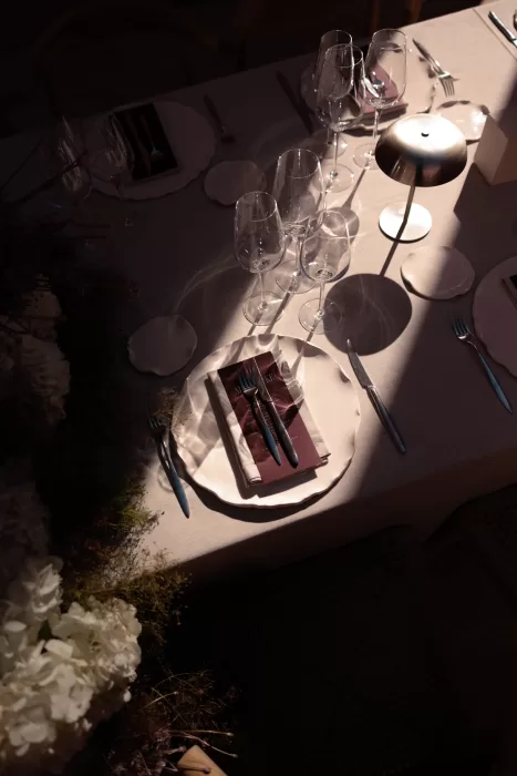 Elegant wedding table set with crystal glassware and soft evening light at Neuendorf House.