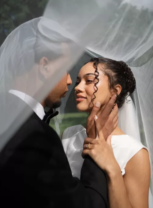 Romantic close-up of the couple under the bride’s veil at The Plummer House gardens.