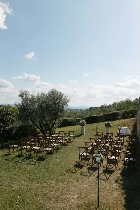 Outdoor wedding ceremony setup overlooking olive trees and rolling hills at Quercia al Poggio.