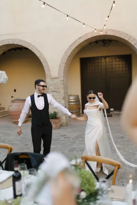 Bride and groom dancing under string lights in the courtyard at Quercia al Poggio.