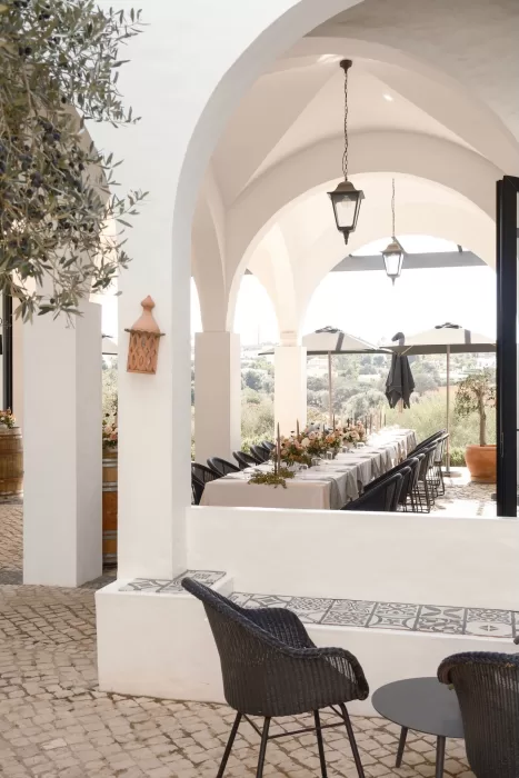 Arched terrace at Quinta Dos Santos set for an intimate wedding dinner with views of olive trees and rolling hills.