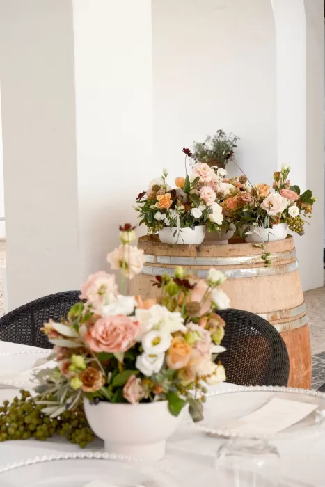 Soft peach and white floral centerpieces decorate the wedding tables at Quinta Dos Santos.