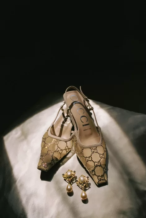 Gucci bridal heels with gold pearl earrings styled together for Sergeants Mess wedding.