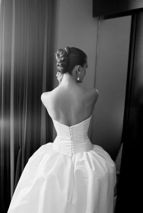 Black and white shot of bride showing buttoned back of her gown at Sergeants Mess.