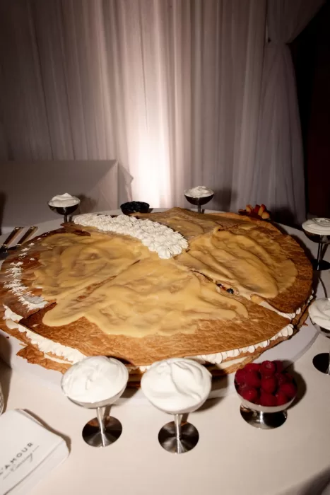Large layered wedding cake with cream and berries served at Sergeants Mess reception.