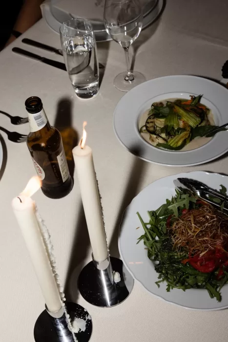 Wedding dinner table with gourmet dishes, candles, and drinks at Sergeants Mess.