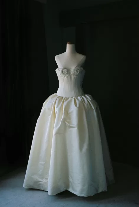 Strapless wedding gown with floral bodice displayed on mannequin at Sergeants Mess.