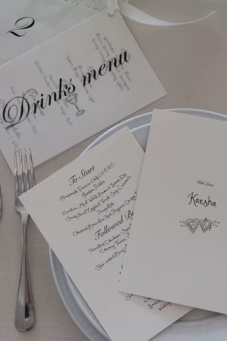 Elegant printed wedding menu and drinks list placed on table setting at Sergeants Mess.