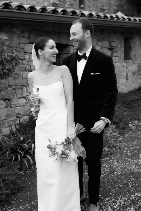 Black and white image of bride and groom laughing together after their ceremony at This Must Be The Place.