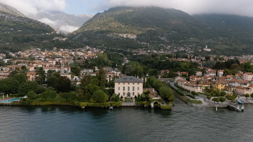 Aerial view of Villa Balbiano surrounded by Lake Como and lush green hills in Italy.