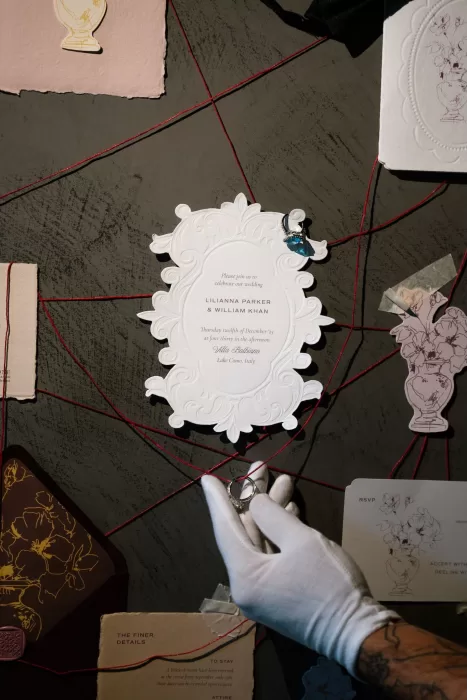 Elegant Villa Balbiano wedding invitation styled with red string and delicate stationery details.