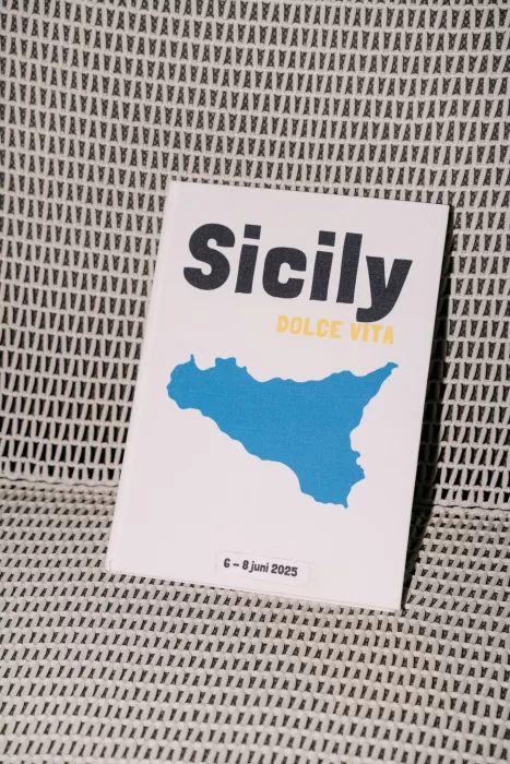 Modern wedding invitation with blue Sicily map and “Dolce Vita” text photographed at Dimora Delle Balze.