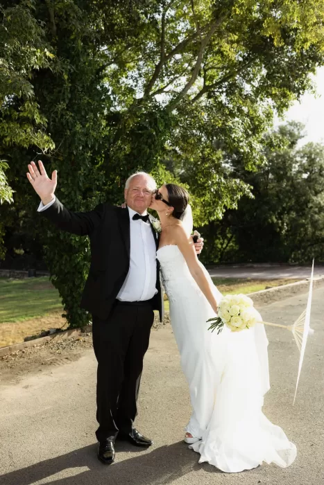 Bride kissing her father on the cheek during a joyful moment at Mas del Sord.