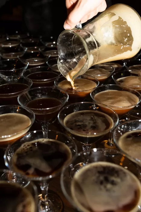 Espresso martinis being poured into cocktail glasses during the reception at Mas del Sord.