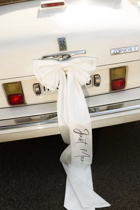 White “Just Married” ribbon tied to the back of a classic Rolls-Royce at Mas del Sord.