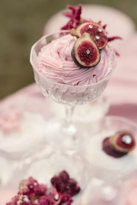 Elegant pink dessert topped with fresh figs and delicate florals at Villa Buttafava.