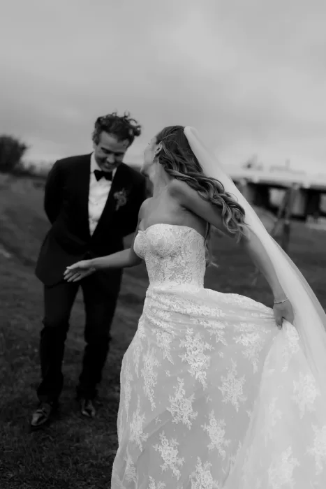 Black and white portrait of the bride laughing during a quiet moment with the groom at Areias do Seixo.