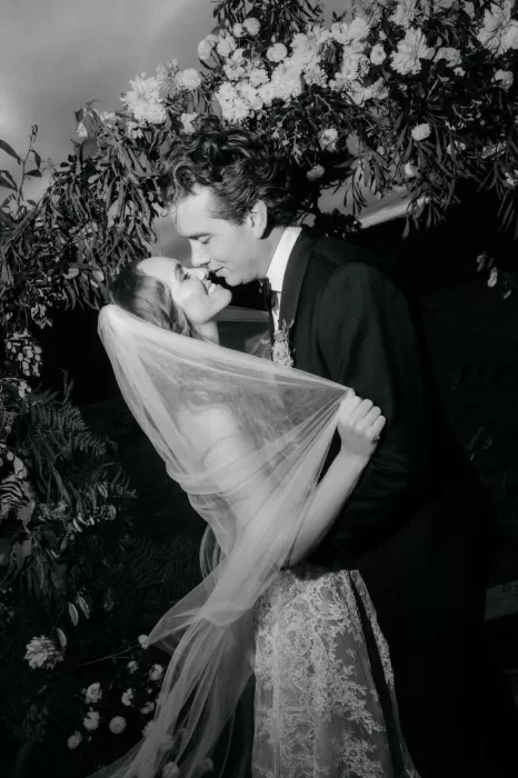 Black and white portrait of the bride and groom sharing an intimate moment beneath her veil at Areias do Seixo.