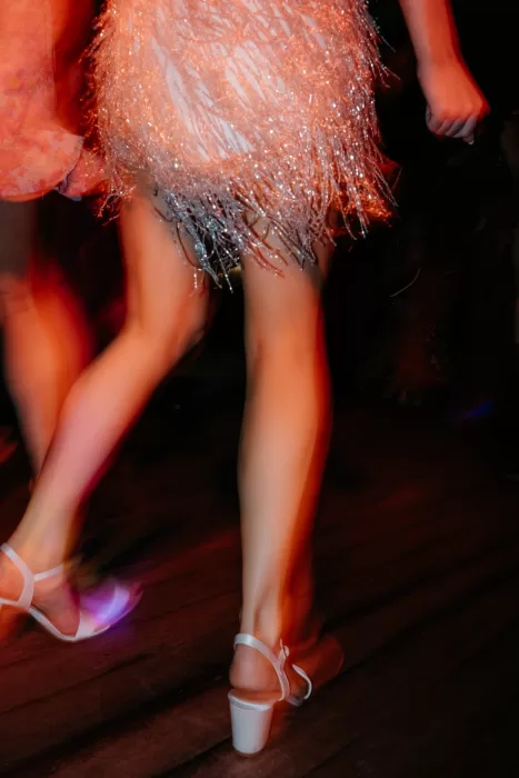 Close-up of the bride’s shoes and dress fringe moving across the dance floor at Areias do Seixo.