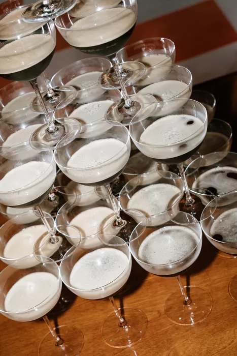 Espresso martini cocktails stacked in coupe glasses at Baja Luna, styled for an elegant wedding reception.