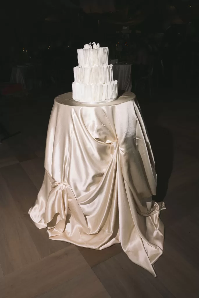 White tiered wedding cake displayed during the evening reception at Boturich Castle.