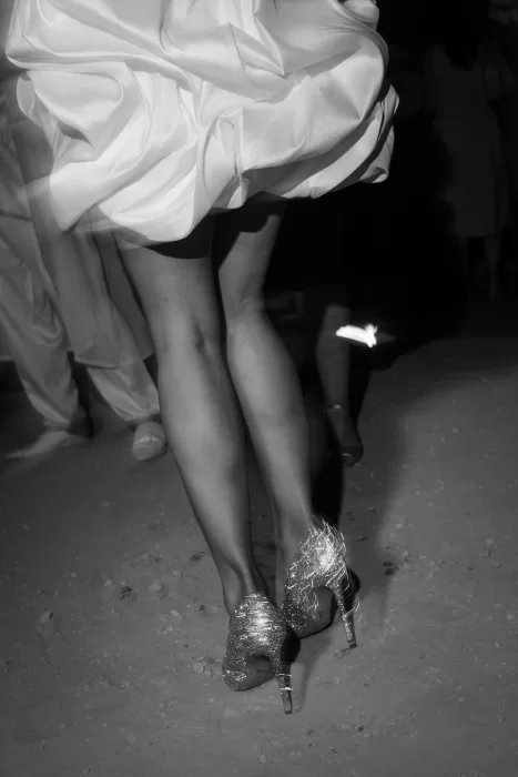 Black-and-white image of the bride’s shimmering heels as she dances at Jnane Tamsna.