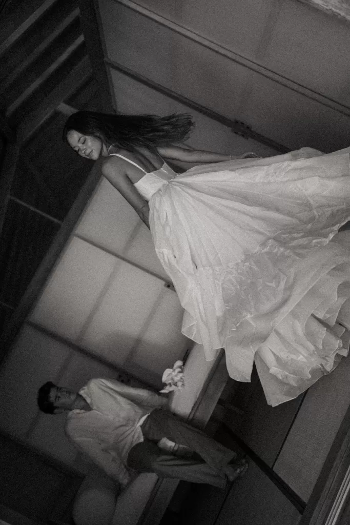 Black and white image of the bride twirling inside Ossipoff’s Cabin, capturing movement and an editorial wedding mood.