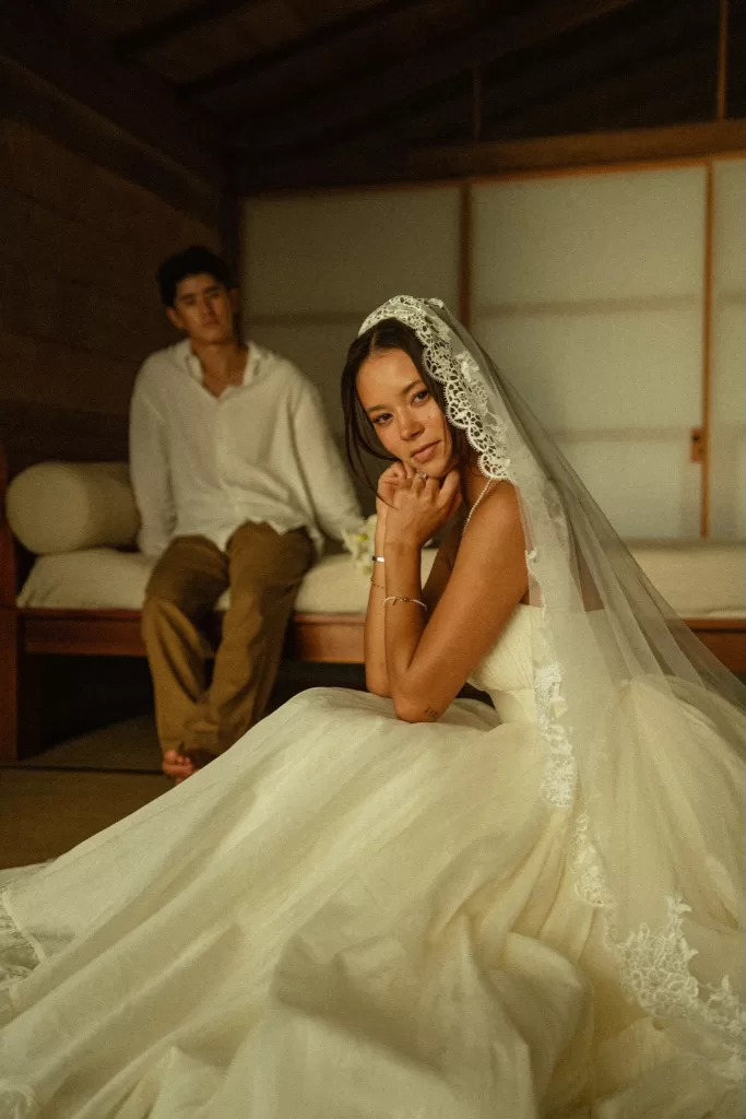 Bride seated inside Ossipoff’s Cabin wearing a lace veil, with a relaxed, editorial wedding mood.