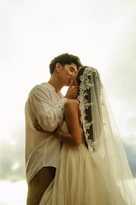 Intimate close-up of the couple kissing at sunset, with soft light framing their wedding moment at Ossipoff’s Cabin.