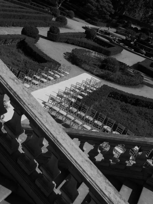Outdoor wedding ceremony seating arranged among formal garden hedges at Vandelli Botanical Garden.