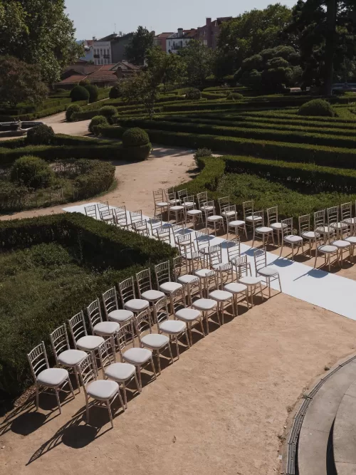 Aerial view of outdoor wedding ceremony setup surrounded by manicured gardens at Vandelli Botanical Garden.
