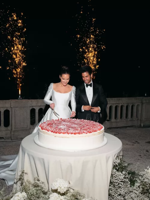 Bride and groom cutting the wedding cake with sparkler fountains at Villa Lario Resort