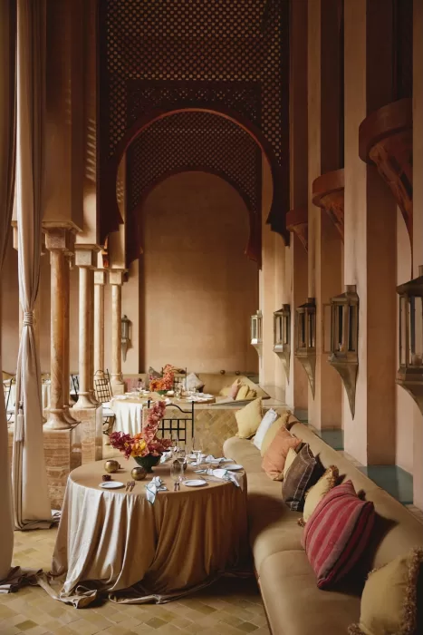 Wedding décor surrounding the courtyard fountain at Amanjena, with marigolds, candles, florals and soft natural light.