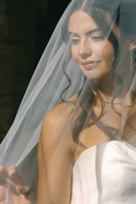 Close-up bridal portrait captured through a soft veil, highlighting natural light at Finca Es Convent.