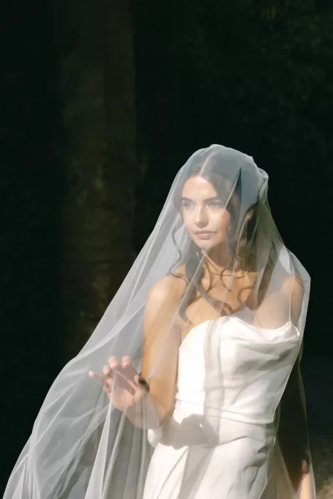 Bride framed in soft light beneath her veil, creating an intimate and romantic portrait at Finca Es Convent.