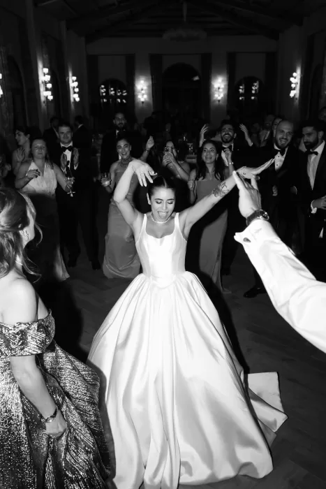 Bride dancing joyfully surrounded by guests during the wedding reception at Finca La Concepción.