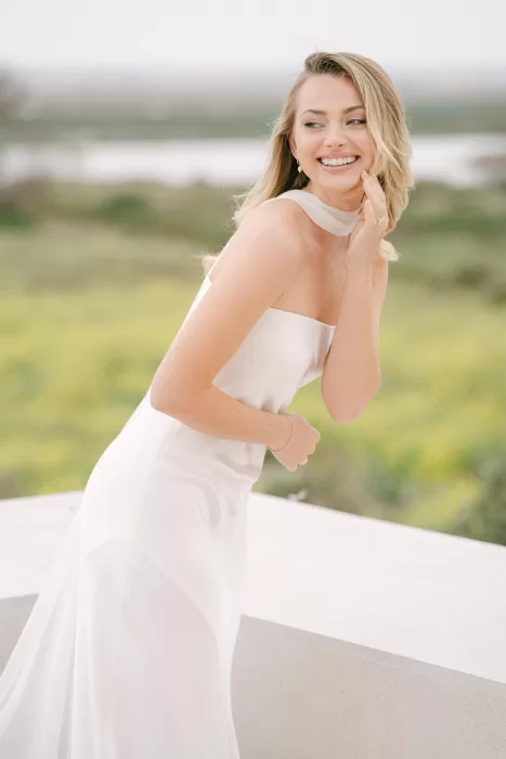 Bride smiling outdoors at Fontsanta with soft natural light and countryside views in the background.