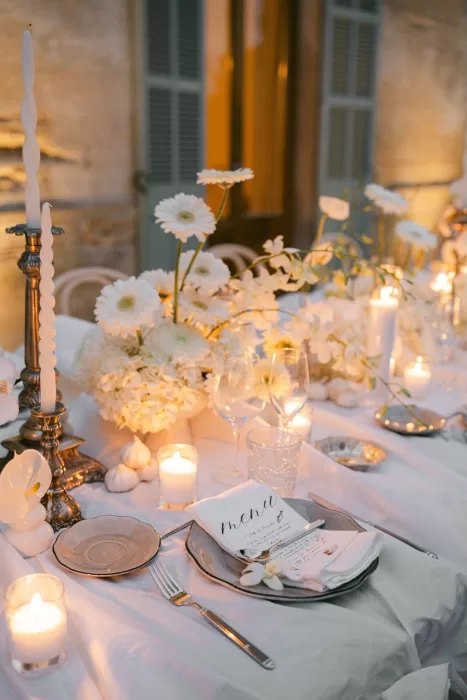 Candlelit wedding table details at Fontsanta with white florals, menus and elegant evening styling.