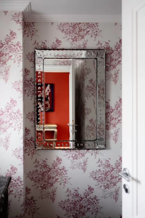Decorative mirror and floral wallpaper inside a suite at Grand Hotel du Lac, highlighting the hotel’s classic interior style.