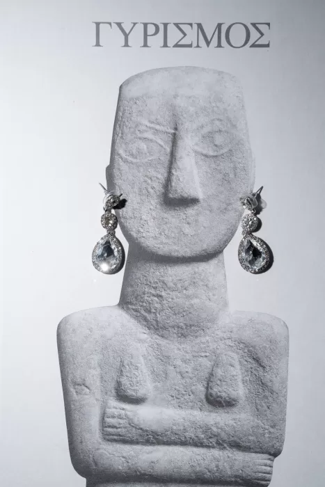 Statement bridal earrings styled on a sculptural display, photographed as part of a wedding at Islet Santorini.