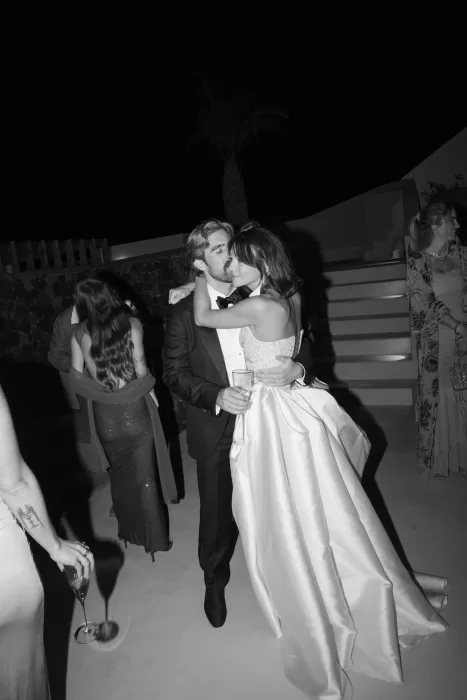 Bride and groom embracing during a night-time wedding reception at Islet Santorini, captured in black and white.