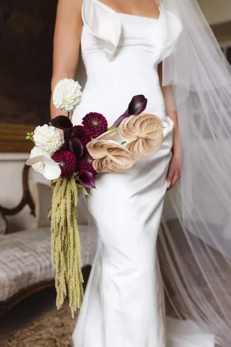 Bridal bouquet with sculptural florals held by the bride inside Boturich Castle.
